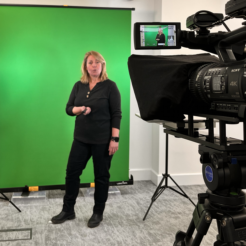 Woman filming a green screen video for Switched-on films and content